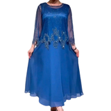 Elegant ensfarvet kjole med skinnende transparent toplag